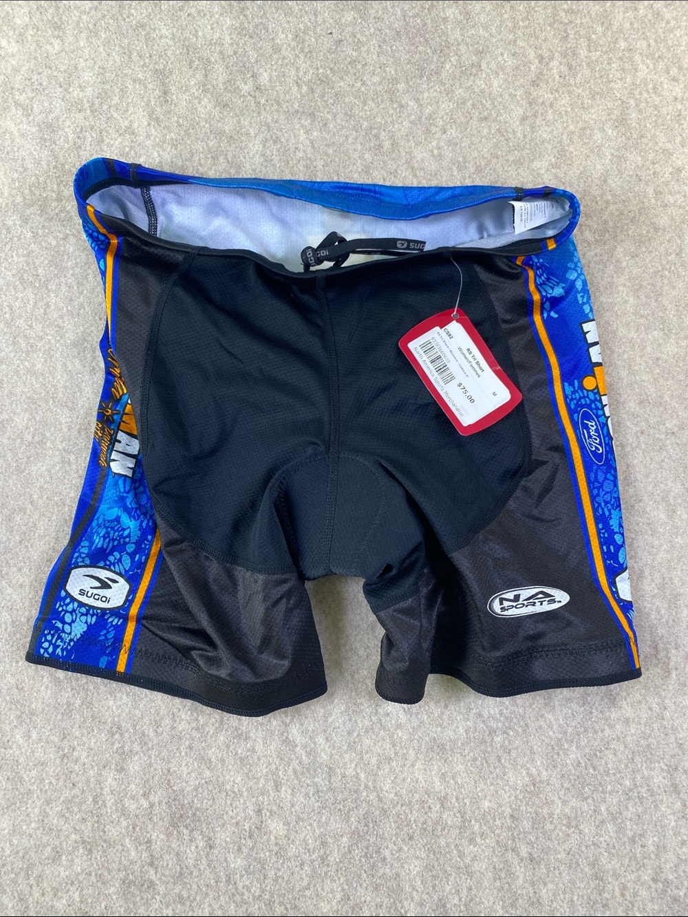 SUGOI Women's Black and Blue Athletic Cycling Shorts with Orange Accents
